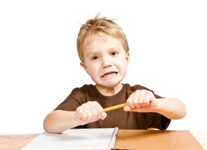 Frustrated-boy-breaking-pencil